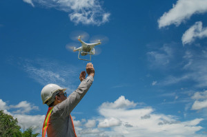 Young engineer use drones outdoor with beautiful sky with clouds