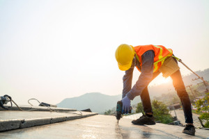 Roofer worker in protective uniform wear and gloves,Using air or